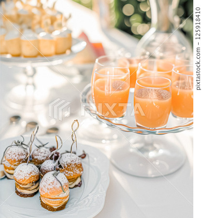 Outdoor wedding buffet table with lavender and a variety of dishes. 125918410