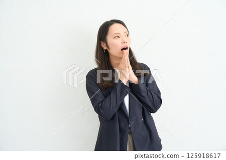Long-haired woman wearing a jacket, surprised Long-haired woman wearing a jacket, surprised 125918617