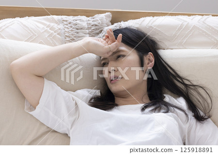 A woman daydreaming in bed 125918891