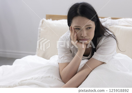 A woman daydreaming in bed 125918892