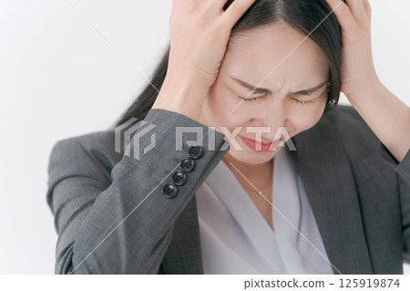 A woman in a suit with a worried expression A woman in a suit with a worried expression 125919874
