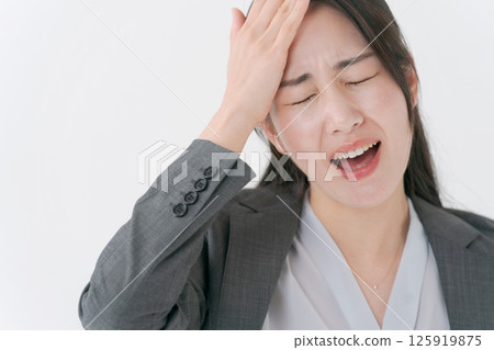 A woman in a suit with a worried expression A woman in a suit with a worried expression 125919875