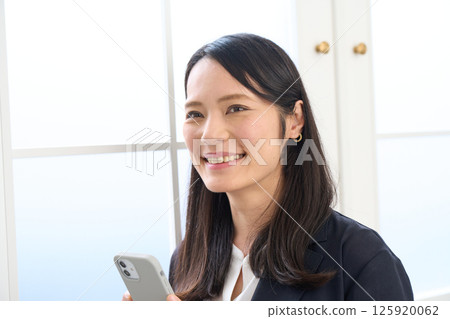 A woman with long hair wearing a jacket A woman with long hair wearing a jacket 125920062