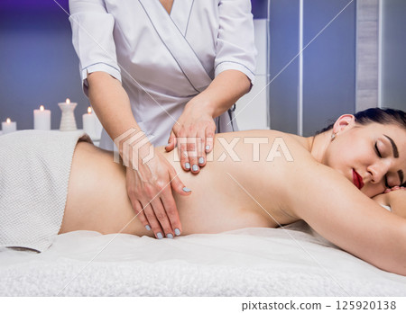 Beautiful young woman enjoying massage in spa salon. Cosmetology Beautiful young woman enjoying massage in spa salon. Cosmetology 125920138