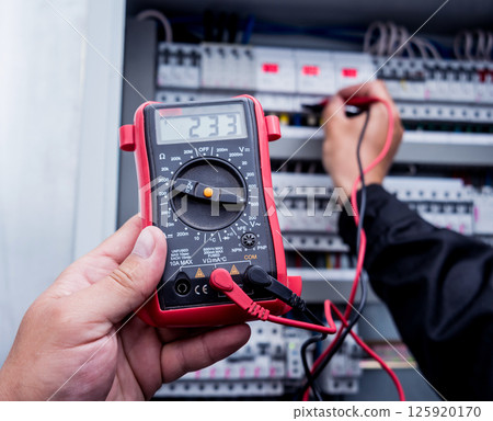 Electrical measurements with multimeter tester. Modern electrical background. 125920170