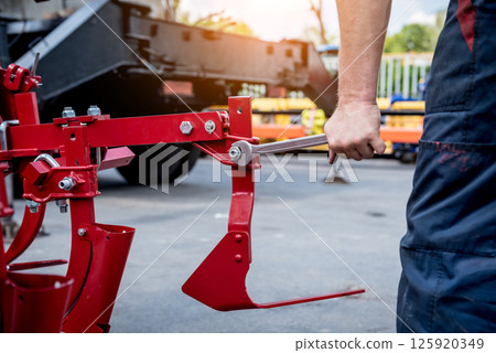 The mechanics repair combine harvester. Modern agricultural machinery 125920349