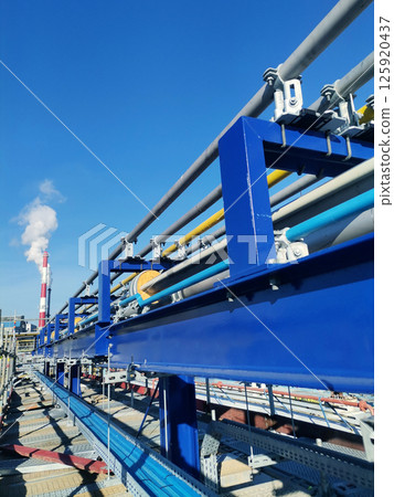 Steel structure is under construction on the construction site against a blue sky backdrop 125920437