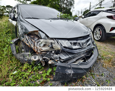 Abandoned cars after accidents in a dense overgrown setting 125920484