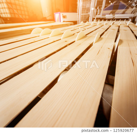 Production line of the wooden floor factory. CNC automatic woodworking machine. 125920677