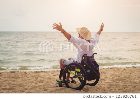 Disabled man in a wheelchair on the beach. 125920761