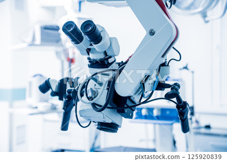Modern microscope for operations in surgery room at the hospital. Modern microscope for operations in surgery room at the hospital. 125920839