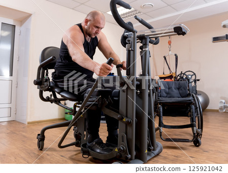 Disabled man training in the gym. Rehabilitation center 125921042
