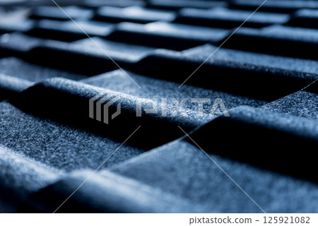 Blue metallic roof tiles background with drops of water. 125921082