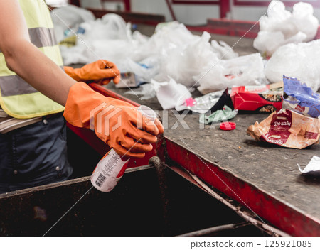 At modern recycling plant. Separate garbage collection. Workers sorting trash At modern recycling plant. Separate garbage collection. Workers sorting trash 125921085
