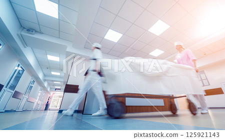 Nurses moves medical stretcher with patient at hospital. Medical equipment. 125921143