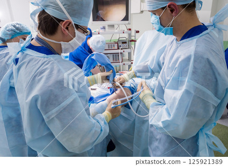 Arthroscope surgery. Orthopedic surgeons in teamwork in the operating room Arthroscope surgery. Orthopedic surgeons in teamwork in the operating room 125921389