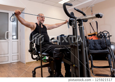 Disabled man training in the gym. Rehabilitation center Disabled man training in the gym. Rehabilitation center 125921517