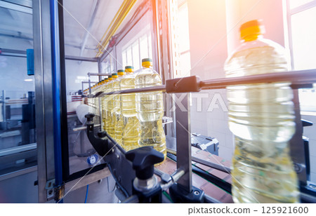 Bottling line of sunflower oil in bottles. Vegetable oil production plant 125921600
