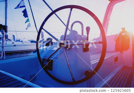 A modern speed boat yacht steering wheels. A modern speed boat yacht steering wheels. 125921605