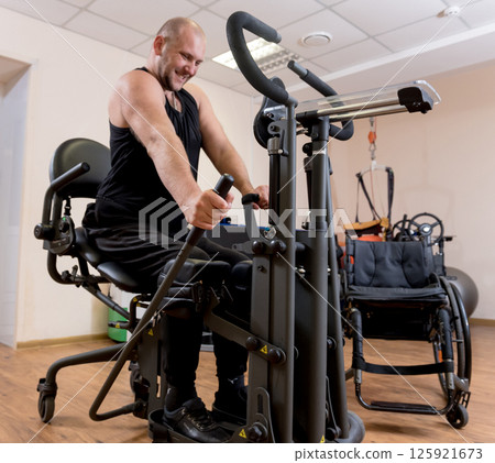 Disabled man training in the gym. Rehabilitation center Disabled man training in the gym. Rehabilitation center 125921673