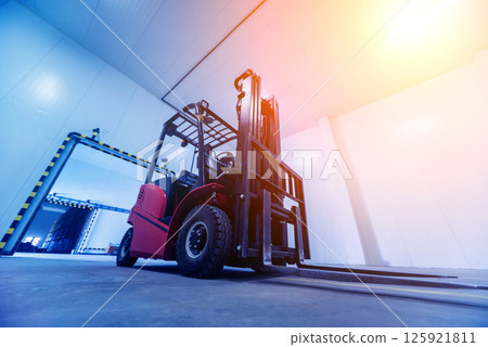 Forklift in a large industrial freezer warehouse. Empty warehouse Forklift in a large industrial freezer warehouse. Empty warehouse 125921811