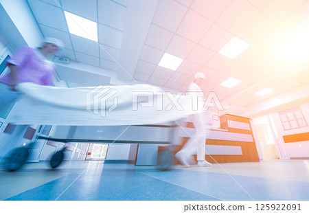 Nurses moves medical stretcher with patient at hospital. Medical equipment. Nurses moves medical stretcher with patient at hospital. Medical equipment. 125922091