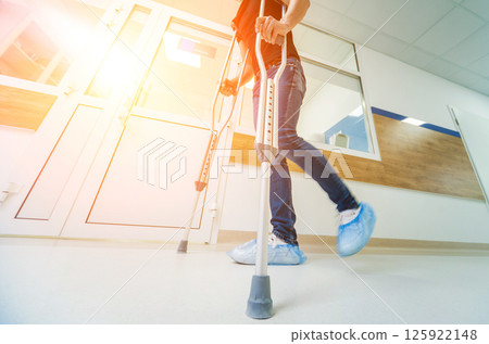 Injured man trying to walk on crutches in the hospital. Injured man trying to walk on crutches in the hospital. 125922148