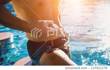 Young athletic man swimming in the swimming pool Young athletic man swimming in the swimming pool 125922276