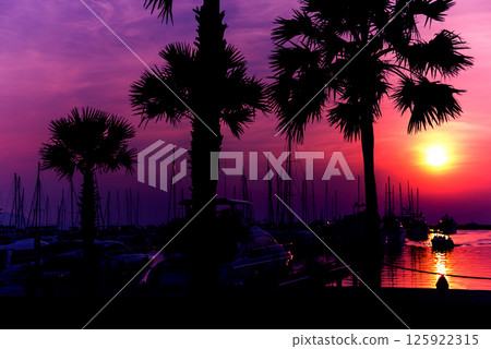 Beautiful sunset sky in the marina bay. View of harbor with yachts Beautiful sunset sky in the marina bay. View of harbor with yachts 125922315