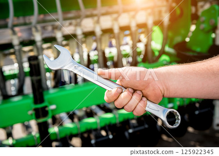 The mechanics repair combine harvester. Modern agricultural machinery The mechanics repair combine harvester. Modern agricultural machinery 125922345