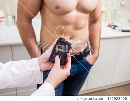 The doctor connects an insulin pump to a patient with diabetes The doctor connects an insulin pump to a patient with diabetes 125922406