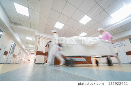 Nurses moves medical stretcher with patient at hospital. Medical equipment. 125922431