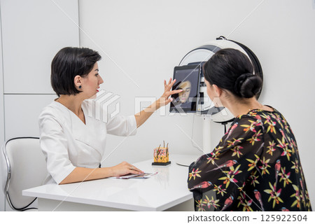Face skin analyze system. Cosmetologist analyzing woman face. Face skin analyze system. Cosmetologist analyzing woman face. 125922504