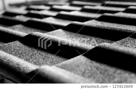 Gray metallic roof tiles background with light pattern. Gray metallic roof tiles background with light pattern. 125922609