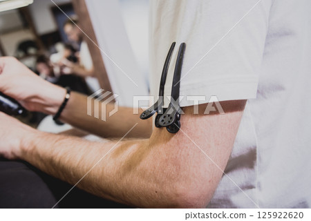 Young man with trendy haircut at barber shop.  125922620