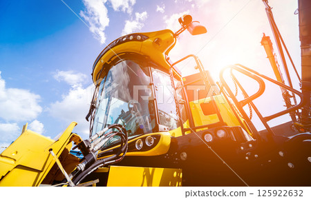 Modern agricultural machinery and equipment. Yellow agricultural harvester. Modern agricultural machinery and equipment. Yellow agricultural harvester. 125922632