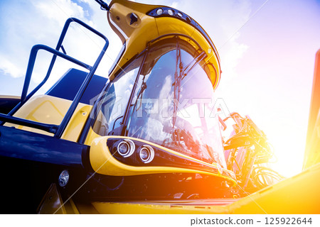 Modern agricultural machinery and equipment. Yellow agricultural harvester. 125922644
