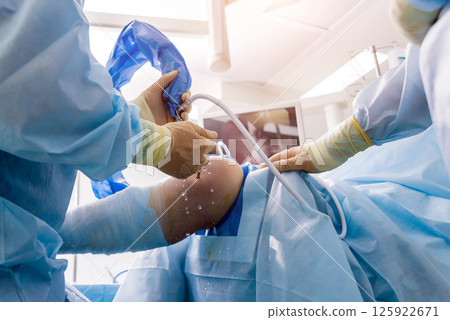 Arthroscope surgery. Orthopedic surgeons in teamwork in the operating room  125922671