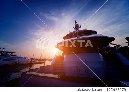 Beautiful view of marina and harbor with yachts and motorboats.  125922679
