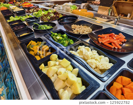 A salad bar featuring an extensive variety of fresh vegetables and fruits 125922782
