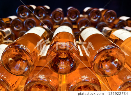 Many bottles of wine neatly arranged on a shop shelf 125922784