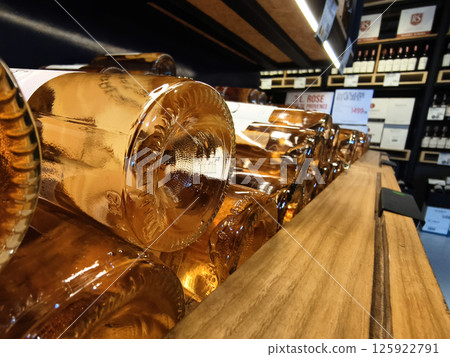 Many bottles of wine neatly arranged on a shop shelf 125922791