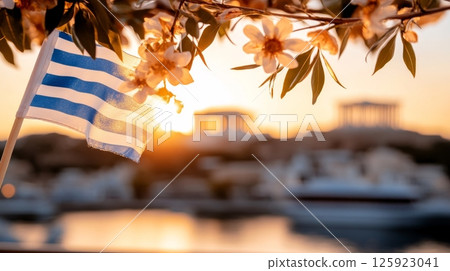Greek flag and flowers at sunset overlooking ancient temples. Concept for Greece Independence Day Greek flag and flowers at sunset overlooking ancient temples. Concept for Greece Independence Day 125923041