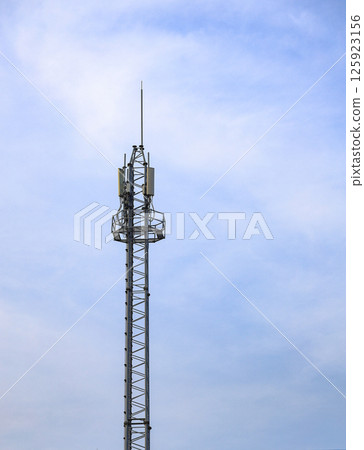 Wireless Communication Antenna pole, Mobile phone mast antenna pole on top of dilapidated building. 125923156