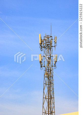 Wireless Communication Antenna pole, Mobile phone mast antenna pole on top of dilapidated building. Wireless Communication Antenna pole, Mobile phone mast antenna pole on top of dilapidated building. 125923222