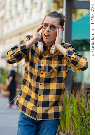 Exhausted man male rubbing temples to cure headache problem suffering from tension migraine stress Exhausted man male rubbing temples to cure headache problem suffering from tension migraine stress 125923228