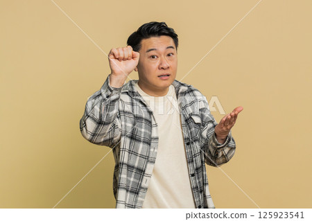 Confused excited Asian man knocking door gesture asking who is at home, feeling embarrassed, no idea Confused excited Asian man knocking door gesture asking who is at home, feeling embarrassed, no idea 125923541