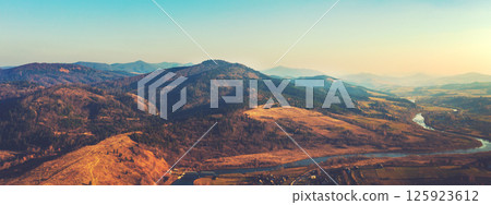 Top view of colorful mountain slopes and river Stryi on a sunny autumn day. Beautiful landscape. Carpathians, Carpathian Ruthenia, Ukraine. Horizontal banner 125923612