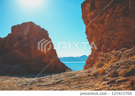 Rocky seascape on a sunny day. Seascape in daylight. View of the sea between two rocks 125923768