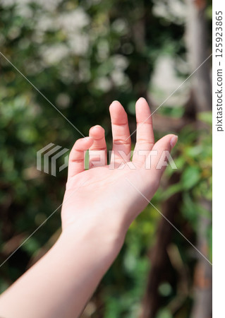 Woman's fingertips in natural light 125923865